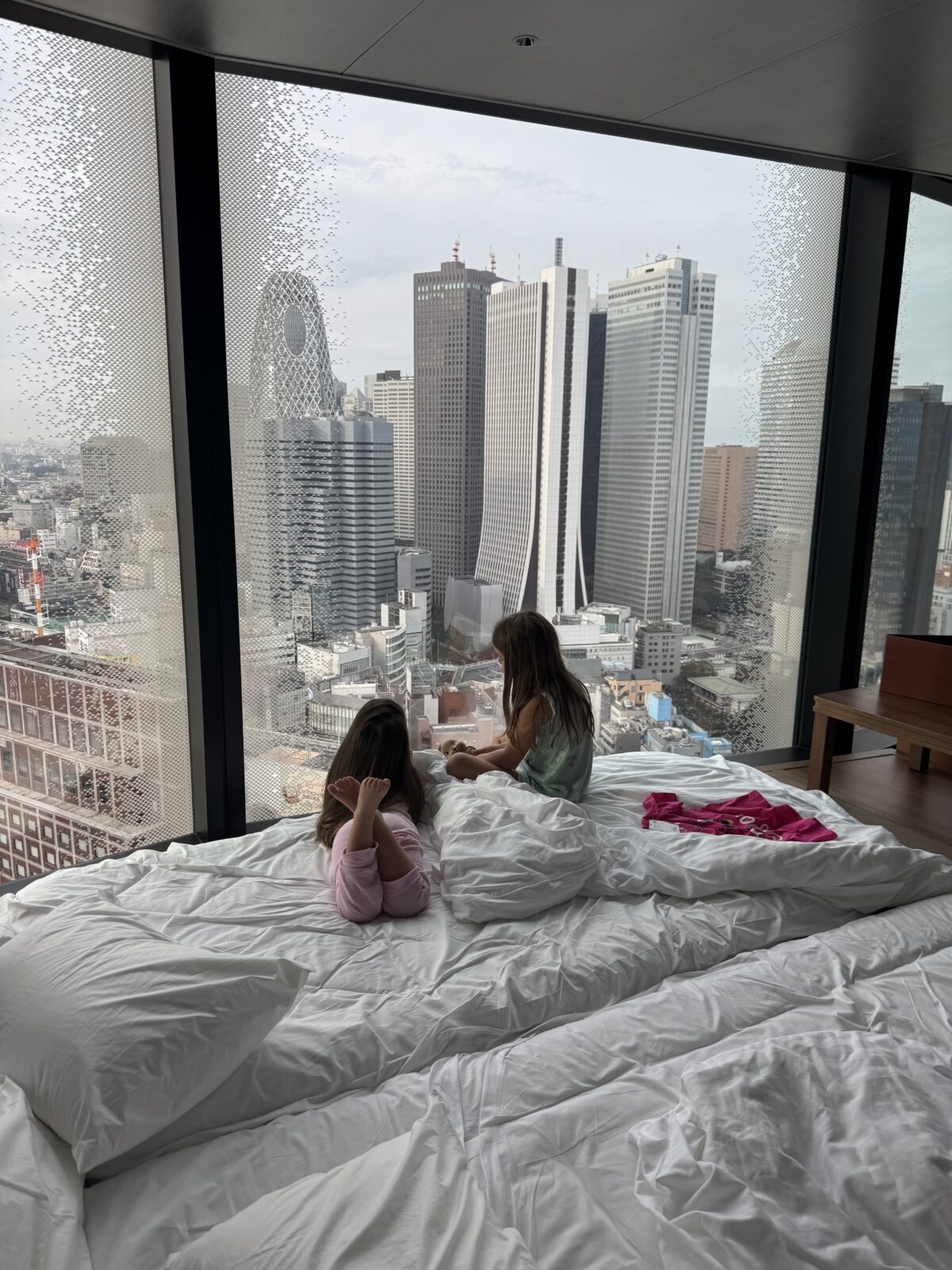 Kids looking out window in tokyo